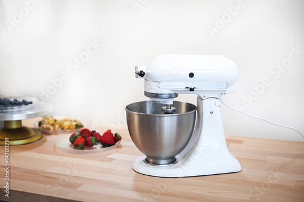 Obraz Planetary mixer on a table with fruit on a white background
