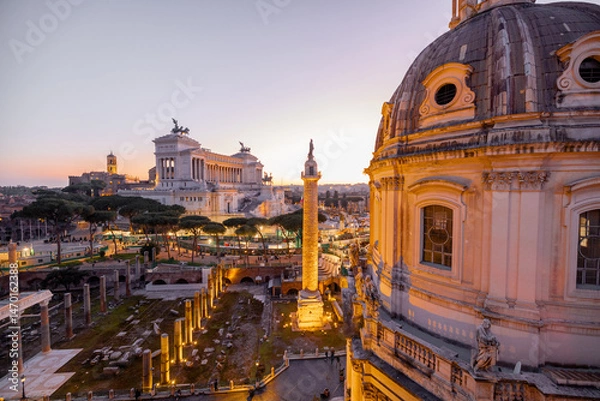 Fototapeta Scenic view of a historic dome and ancient Roman ruins glowing in the sunset light. The iconic Altare della Patria rises in the background above Romes evening skyline