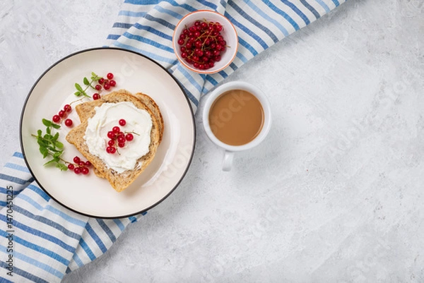 Fototapeta Whole grain sandwich with cream cheese or cottage cheese, mint and red berries top view. Breakfast on light background with copy space