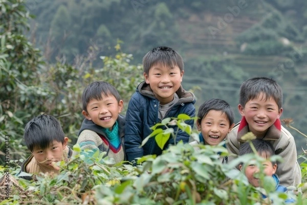 Fototapeta Group of happy asian children smiling and playing in tea plantation.