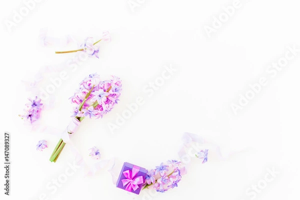 Fototapeta Bouquet of pink flowers, ring box and shabby tapes on white background. Flat lay, top view.