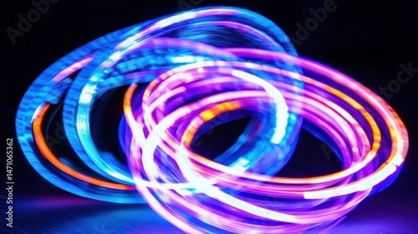 Fototapeta Multicolored light rings in a dynamic, swirling display.
