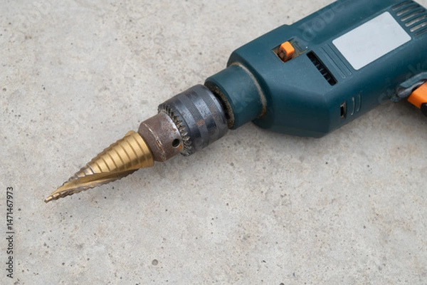 Fototapeta Tool with a cone drill for metal. Attachment for obtaining holes of different diameters