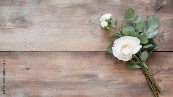 Fototapeta Elegant white ranunculus and eucalyptus bouquet arranged on rustic wooden surface, offering a minimalist floral design with copy space. : Generative AI