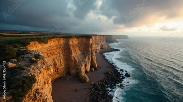 Obraz Dramatic cliffs (Cabo Vidio) under cloudy dawn skies, aerial view.