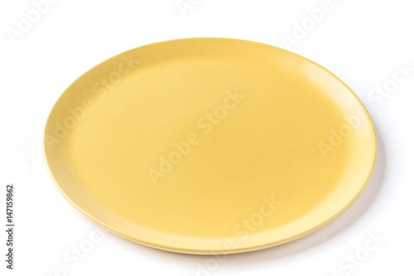 Fototapeta Close up of a round yellow plate on a  white background