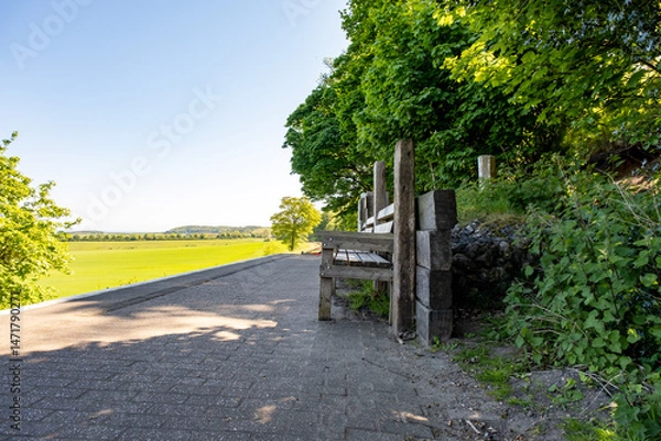 Fototapeta Wooden benches on Kelling rail station on the North Norfolk Railway Line. Captured on a sunny morning Intentional sharp focus and bokeh