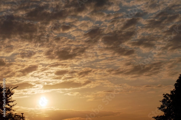 Obraz Sun and cloudy sky at sunset in spring