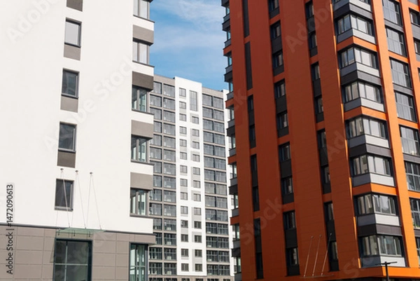 Fototapeta Modern apartment buildings on a sunny day with a blue sky. Facade of a modern apartment building