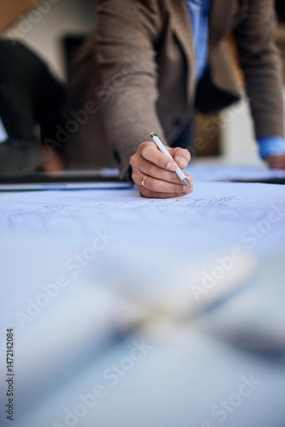 Fototapeta Business Professional Working on Blueprint with Focus and Precision in Office Environment
