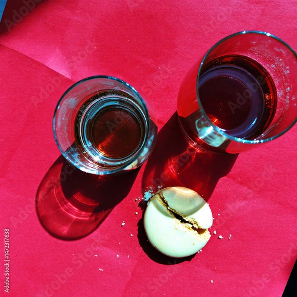 Obraz Glasses of Red Liquid on Red Surface with Artistic Shadows