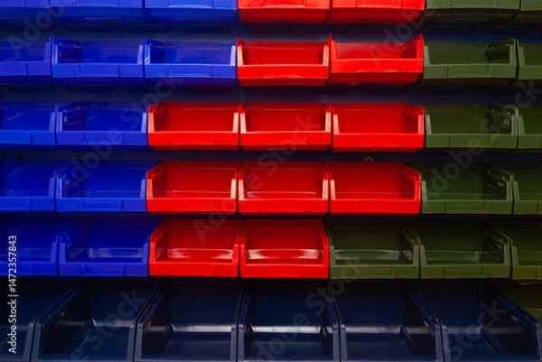 Obraz A wall with plastic containers for storing small parts.