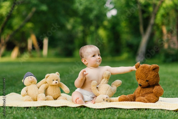 Fototapeta Baby Playing With Plush Bears On Blanket