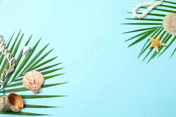 Obraz Flat lay with straw hat, seashells and palm leaf on blue background. Vacation concept