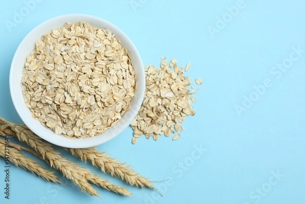 Obraz Composition with oatmeal flakes. Cooking breakfast