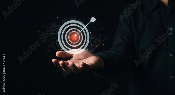Fototapeta professional, in a suit, holding a glowing target, symbolizing strategic business goals, focused objectives, and precise aim for corporate success.