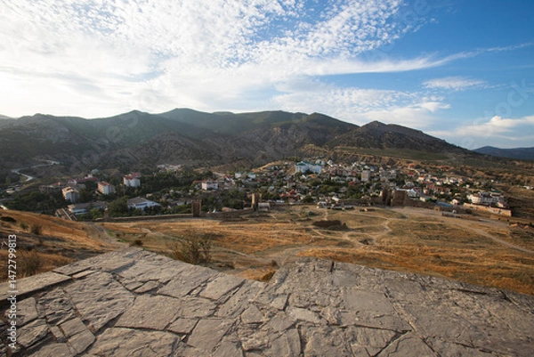 Obraz a landscape showing the city against a backdrop of large mountains, viewed from above