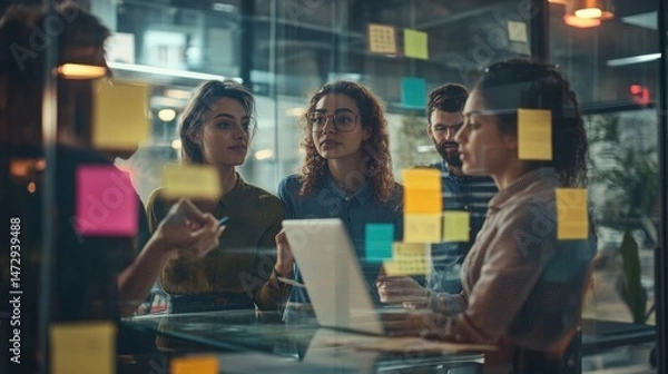 Fototapeta Office Team Collaborating Behind Glass Wall with Sticky Notes Brainstorming