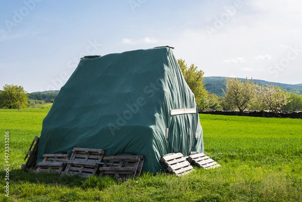 Fototapeta Stack of Hay Covered with Tarp
