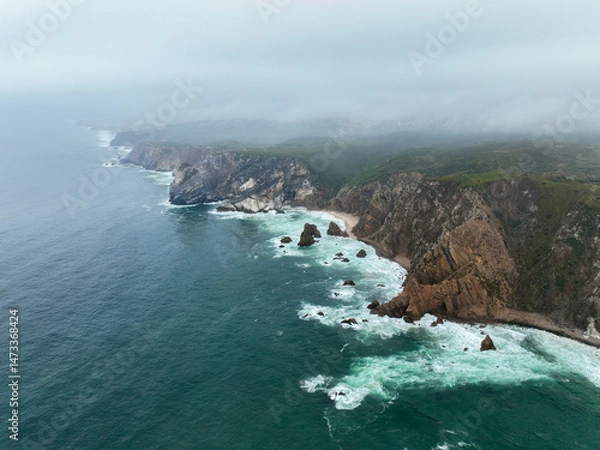 Fototapeta Wide view of rocky coastline with cliffs and crashing Atlantic waves