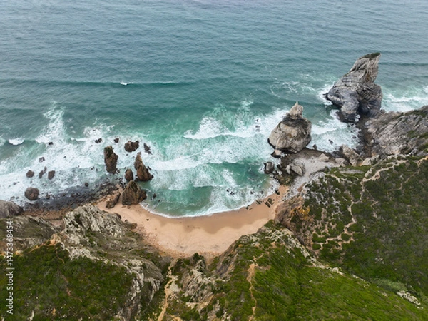 Fototapeta Drone view of Praia da Ursa with rugged rocks and turquoise waves