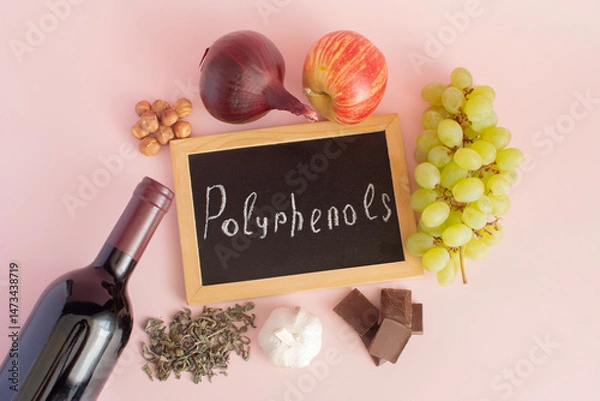 Fototapeta Products containing polyphenols in their composition. Grapes, onions, garlic, chocolate, green tea, close-up on a light background, flat lay