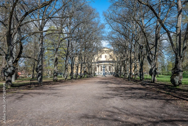 Fototapeta The English Park in Uppsala on a sunny spring day in Sweden at the end of April 2025. This legendary park, which is located behind Carolina Rediviva, dates back to 1825.