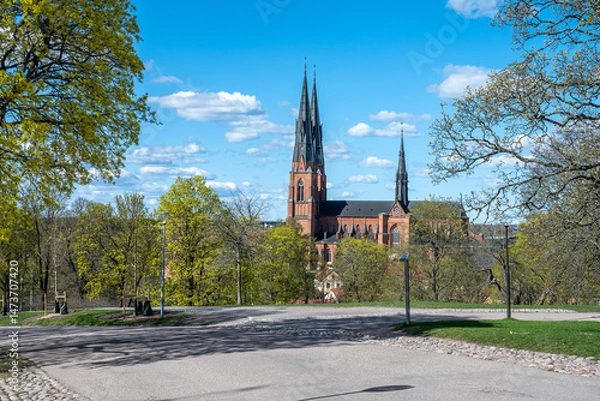 Fototapeta Uppsala Cathedral, the seat of the Archbishop of Sweden, on a sunny spring day in late April 2025. The cathedral was consecrated in 1435. 