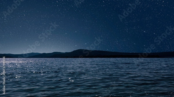 Obraz a a movement of stars in the night sky with the view of mountains.