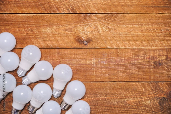 Fototapeta LED bulbs with E27 socket are lying on the table