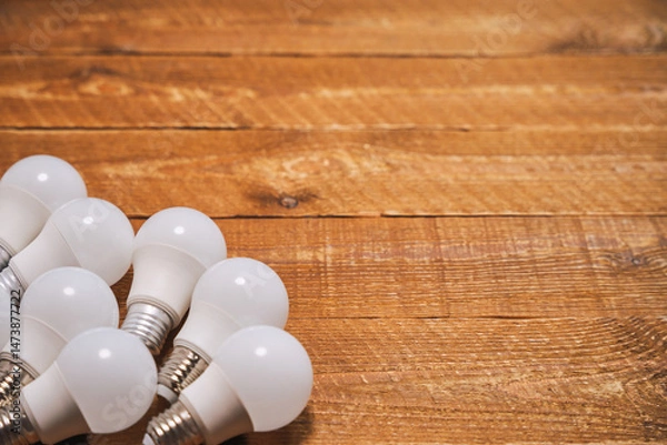 Fototapeta LED lamps with E27 socket are lying on the table