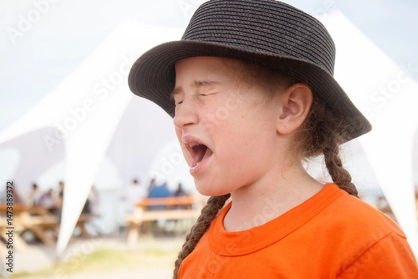 Fototapeta girl grimacing after tasting something sour