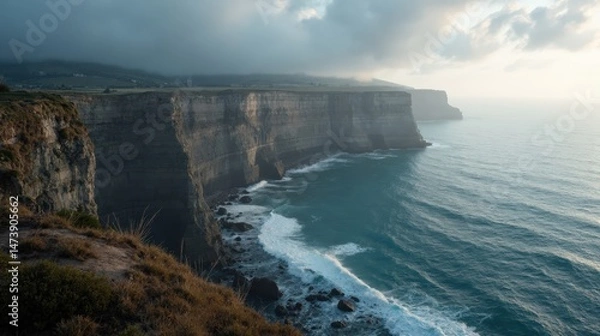 Fototapeta Misty dawn over Cape Ortegal Cliffs (shoreline), seen from a dramatic aerial view.