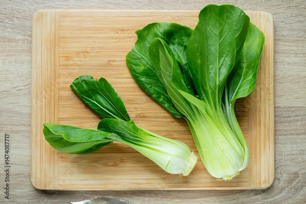 Obraz Fresh Chinese cabbage pak choi on a wooden board.