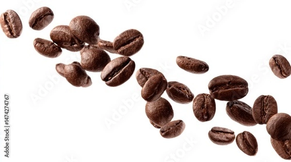 Fototapeta Roasted coffee beans scattered on a white background creating a flowing pattern.