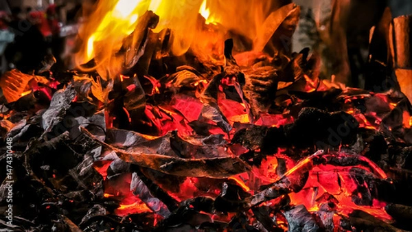 Fototapeta Intense close-up of burning pile with glowing embers and radiant flames