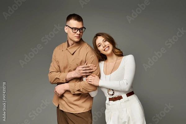 Fototapeta Joyful couple celebrating love with elegance and style in a modern setting