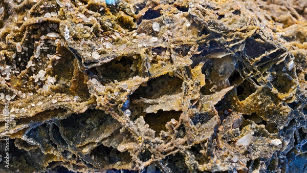 Fototapeta Intricate details of a weathered rock formation with crystalline structures