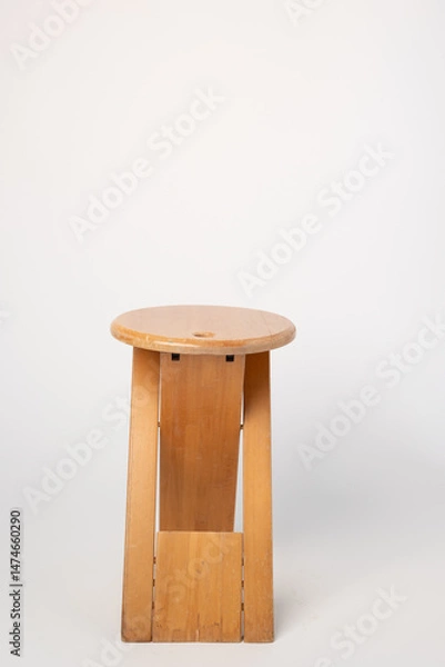 Fototapeta Small, folding, used wooden stool that can also serve as a side table,.