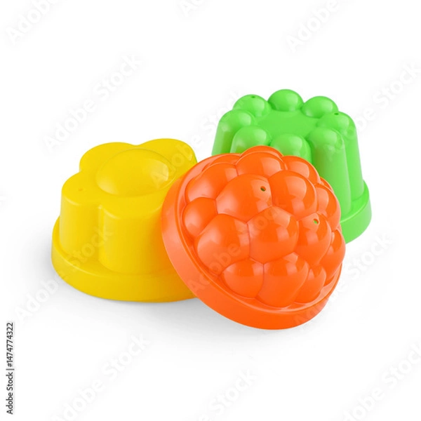 Fototapeta A set of children's molds for creating sand shapes on a white background.