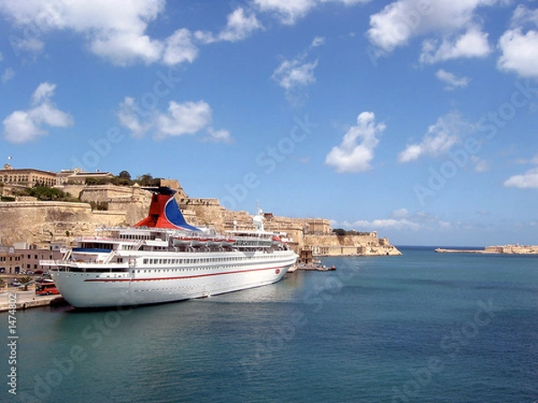 Fototapeta ship off the coast of malta with ocean and clouds