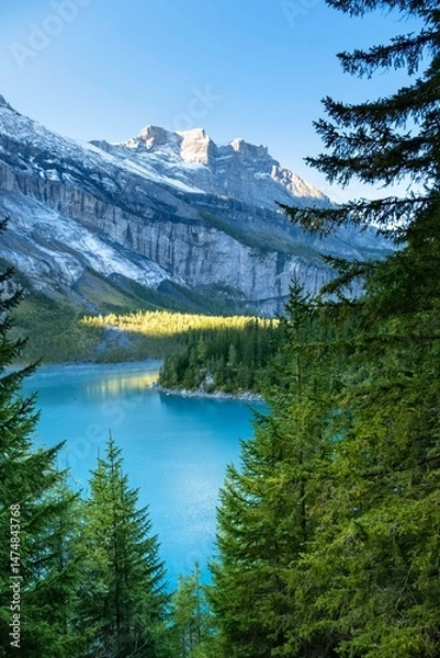 Fototapeta Amazing view of Switzerland Oeschinensee. Turquoise blue alpine lake amidst the snow capped mountains. Summer sunny day in Swiss Alps. Great tourist attraction for active sport and hiking