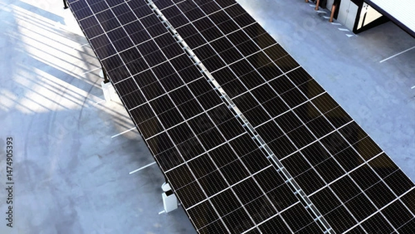 Fototapeta High-Angle View of Solar Panels Installed on Parking Lot Roofs for Sustainable Energy Generation.