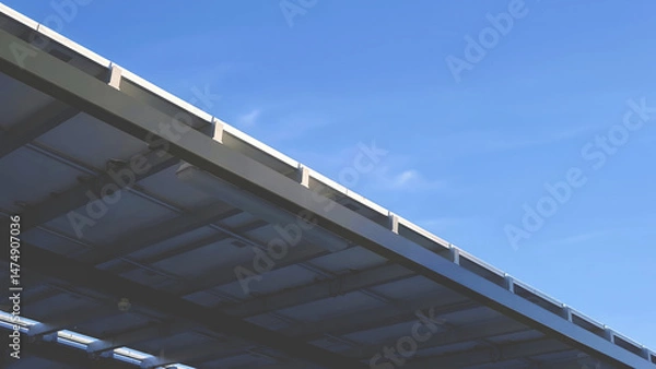 Fototapeta Solar Panel Viewed from Below Against Clear Blue Sky background.