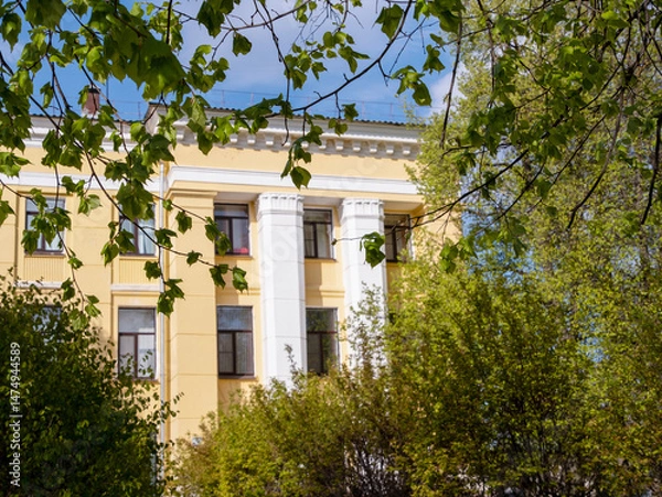 Obraz fragment of yellow administrative building on sunny day, selective focus