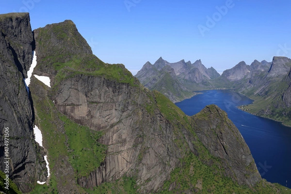 Fototapeta Panoramic aerial view from Mount Reinebringen over mountain peaks and bay of water on the Lofoten Islands in Norway