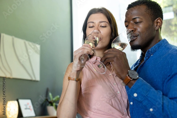 Obraz Couple enjoying wine tasting at home, savoring flavors with closed eyes
