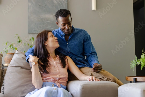 Obraz Couple relaxing on sofa at home, enjoying quality time together