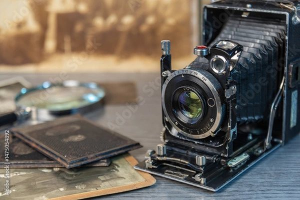 Fototapeta Vintage camera and old photographs create a nostalgic atmosphere in a classic setting