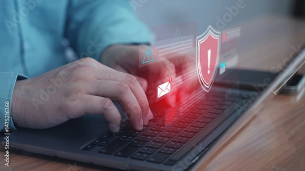 Obraz Close-up finger pressing laptop keyboard with red digital shield — representing firewall activation or access control.